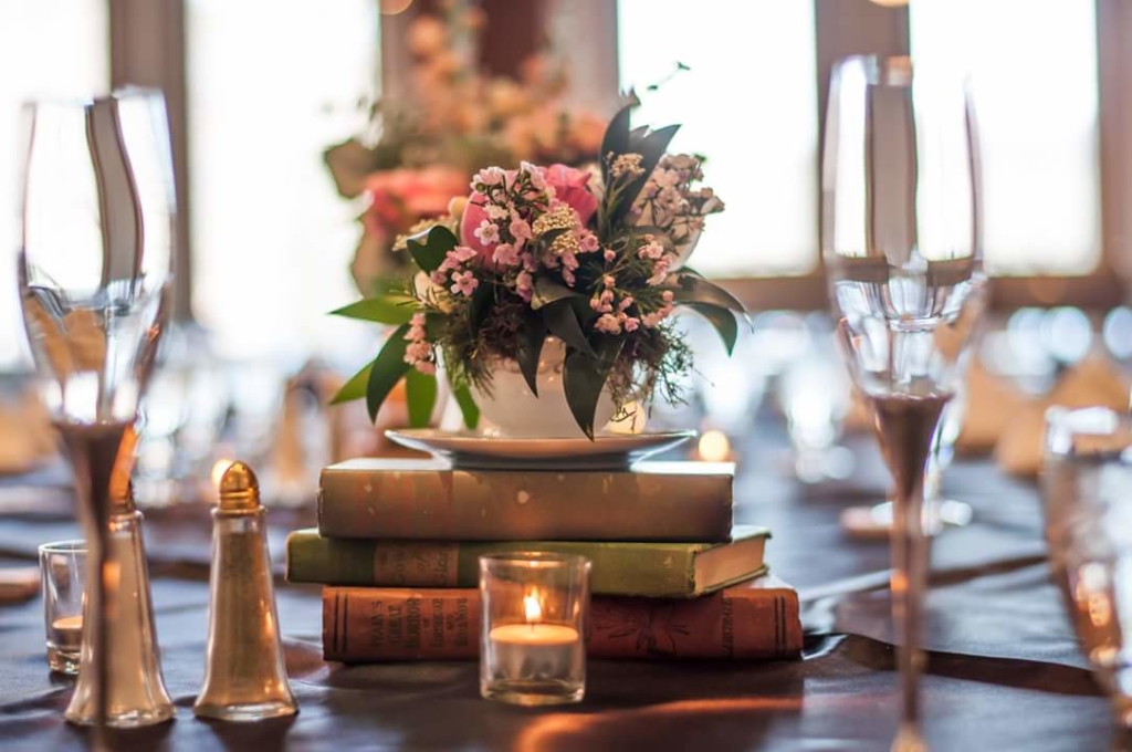 Flower centerpiece on top of books